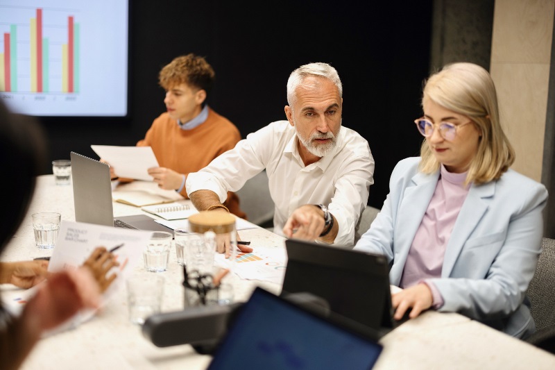 Culture Survey Mistakes Blog Image Three team members at conference table looking at organizational culture survey