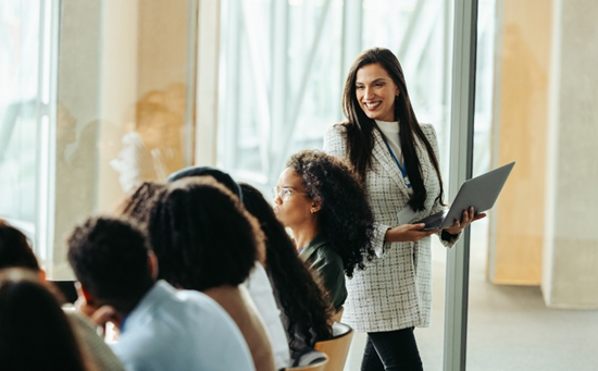 team leader in an office setting smiling at her team